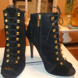 Peep too Black ankle boots with gold studs.